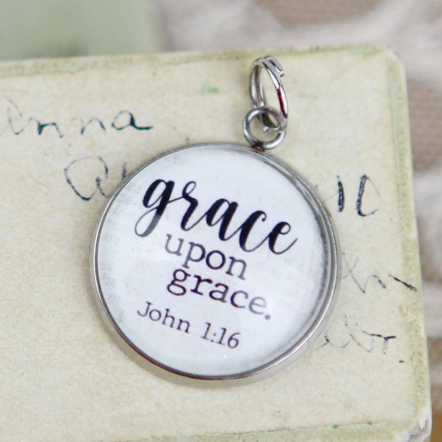 silver jewelry charm that says Grace Upon Grace