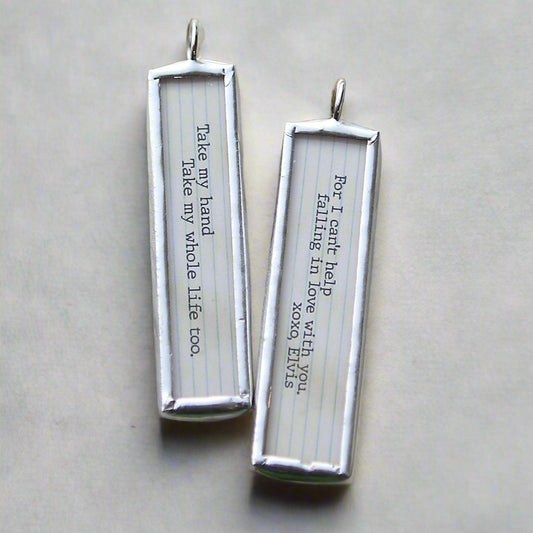 two sided soldered charm with Can't Help Falling In Love lyrics on it
