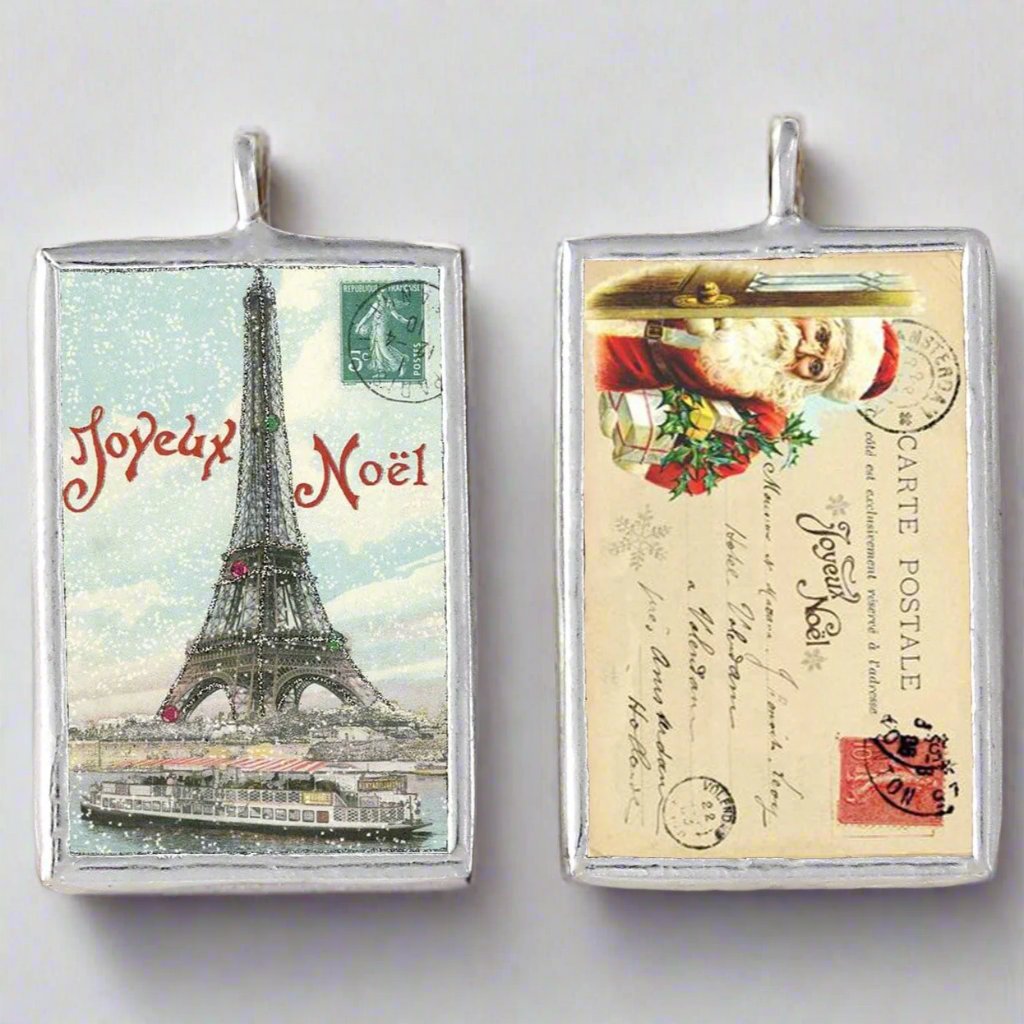 two sided jewelry charm with a vintage eiffel tower photo on one side and a vintage french postcard on the other