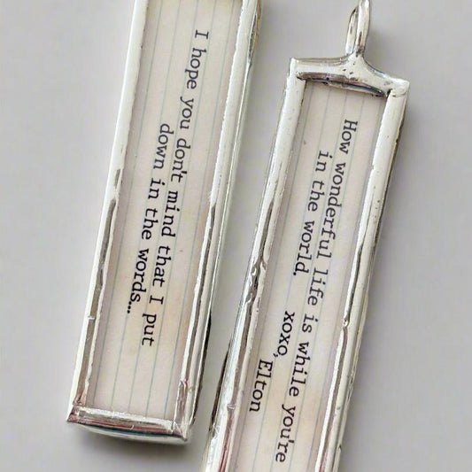 two sided soldered jewelry charm with Your Song Lyrics on it