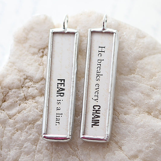 two sided silver jewelry charm that says Fear Is A Liar
