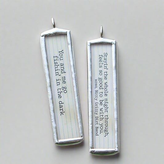 two sided necklace charm that says Fishin in the dark