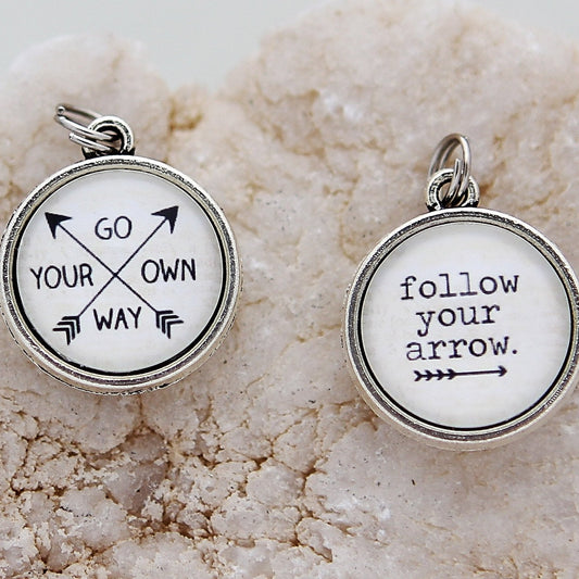 two sided jewelry charm that says Follow Your Arrow
