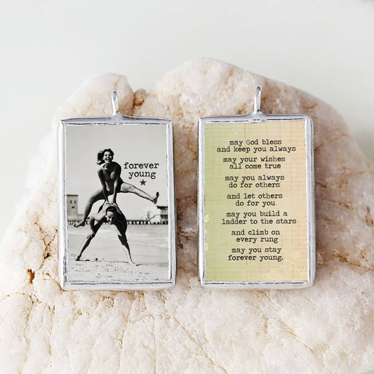 two sided soldered art charm that says Forever Young