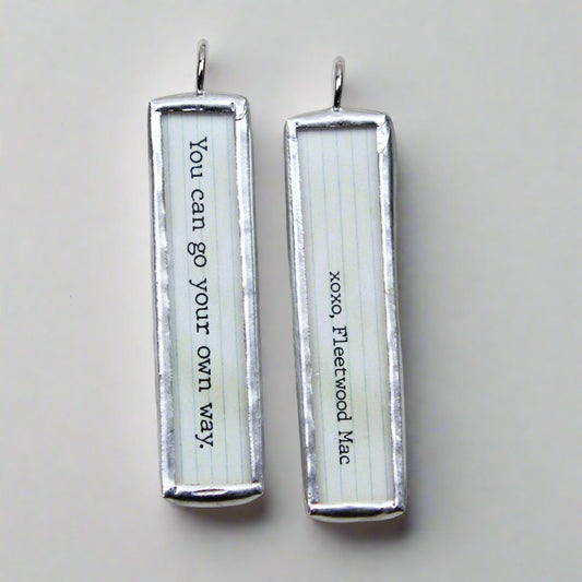 two sided jewelry charm that says You Can Go Your Own Way