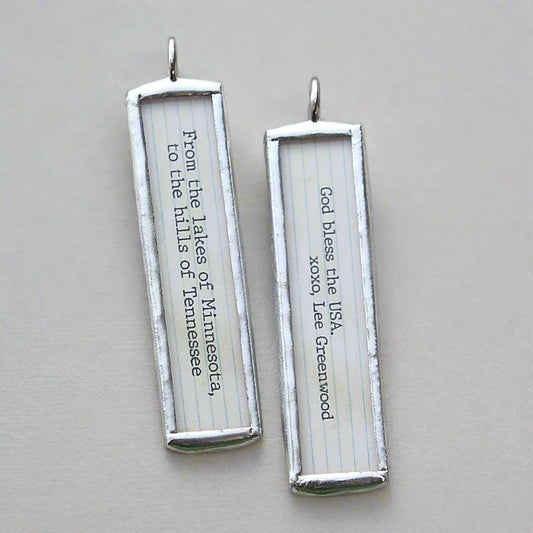 two sided jewelry charm that says God Bless the USA