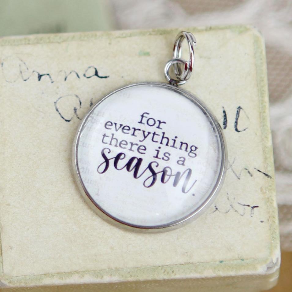 Round jewelry charm that says For Everything There Is A Season