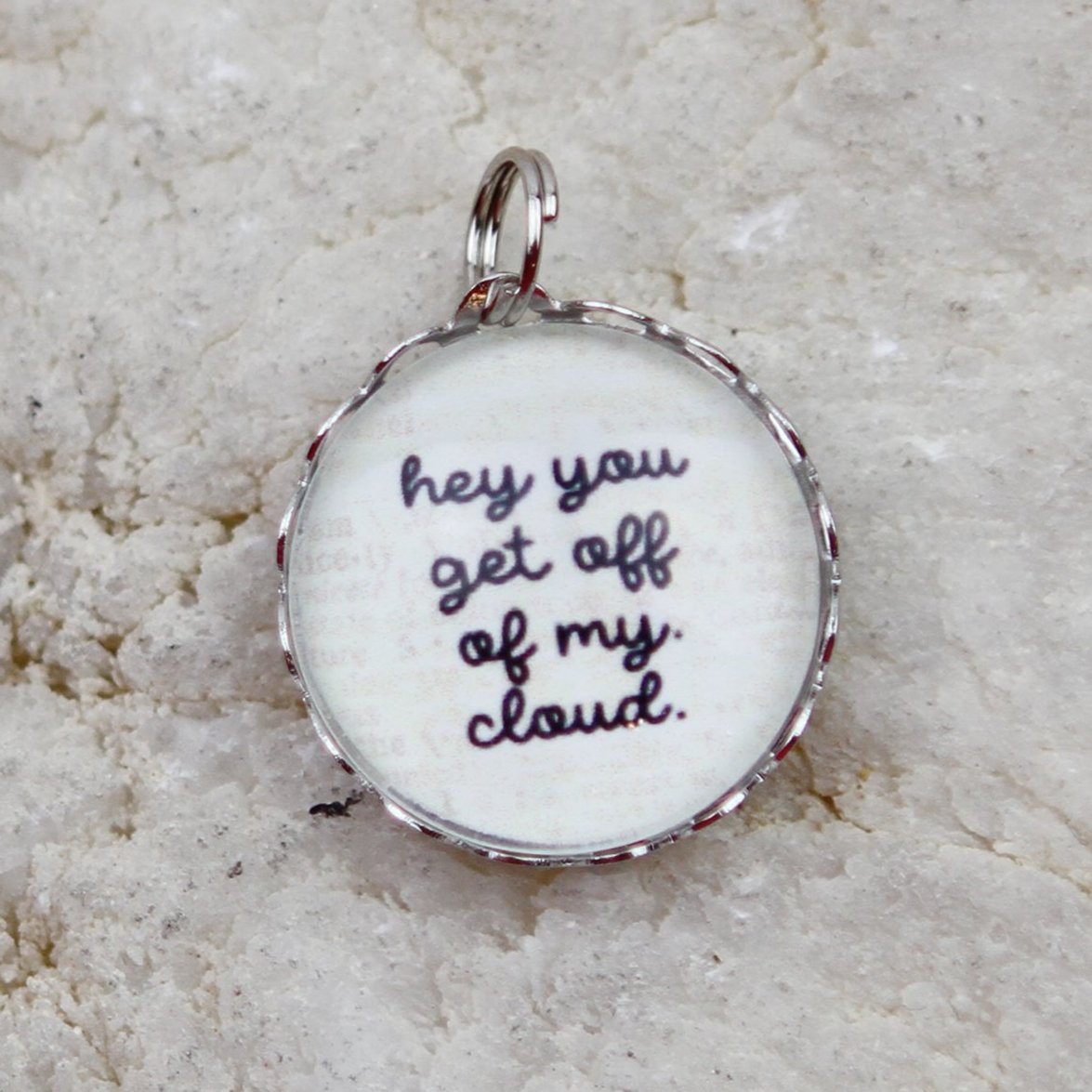 round jewelry charm that says Get Off Of My Cloud
