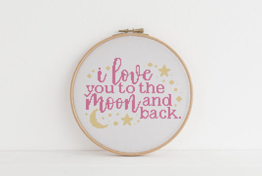 Embroidery hoop with 'I love you to the moon and back' text on a white background