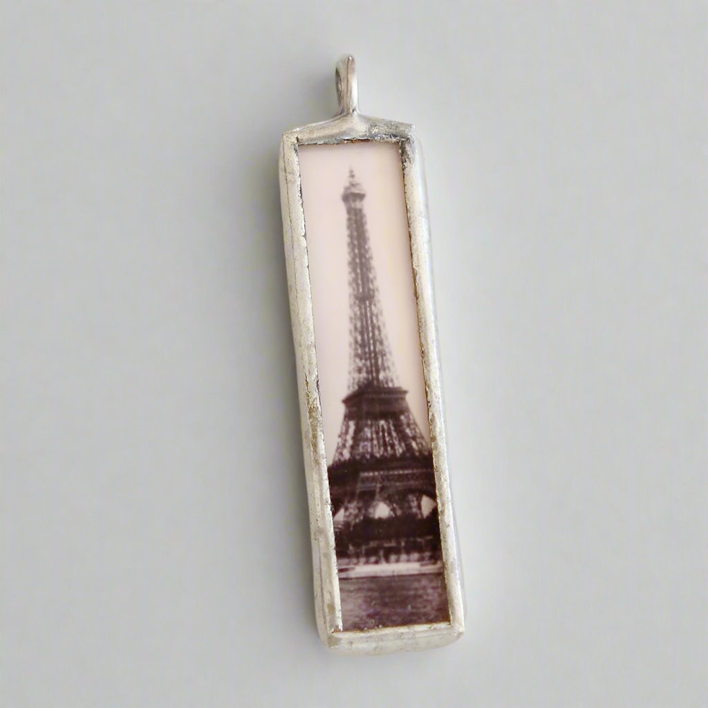 two sided soldered art charm with the Eiffel Tower on one side
