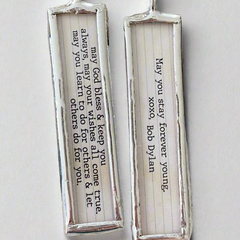 two sided soldered charm that says Forever Young